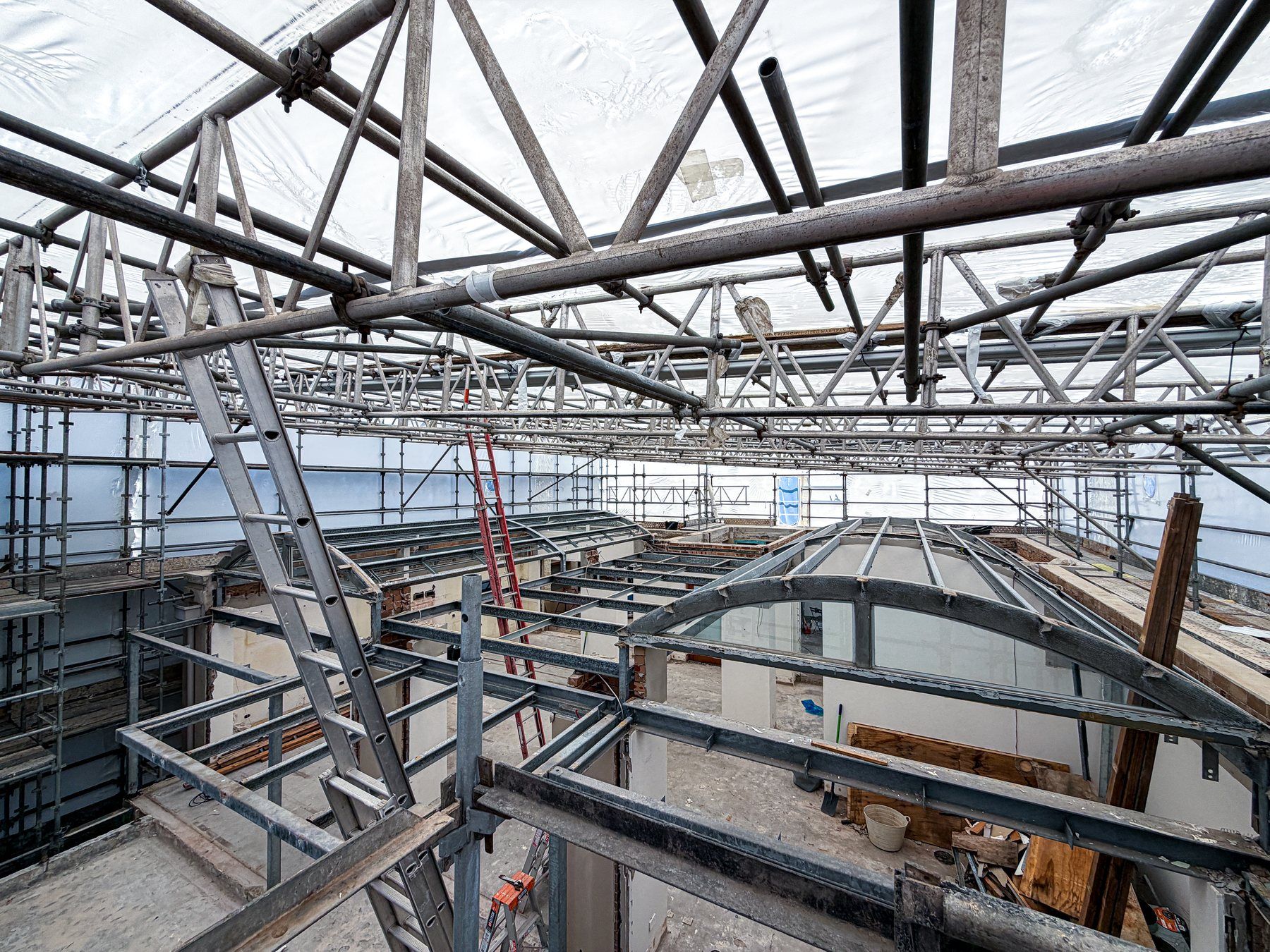 Inside the wrap: the scaffold structure overhead and the renovation underway below
