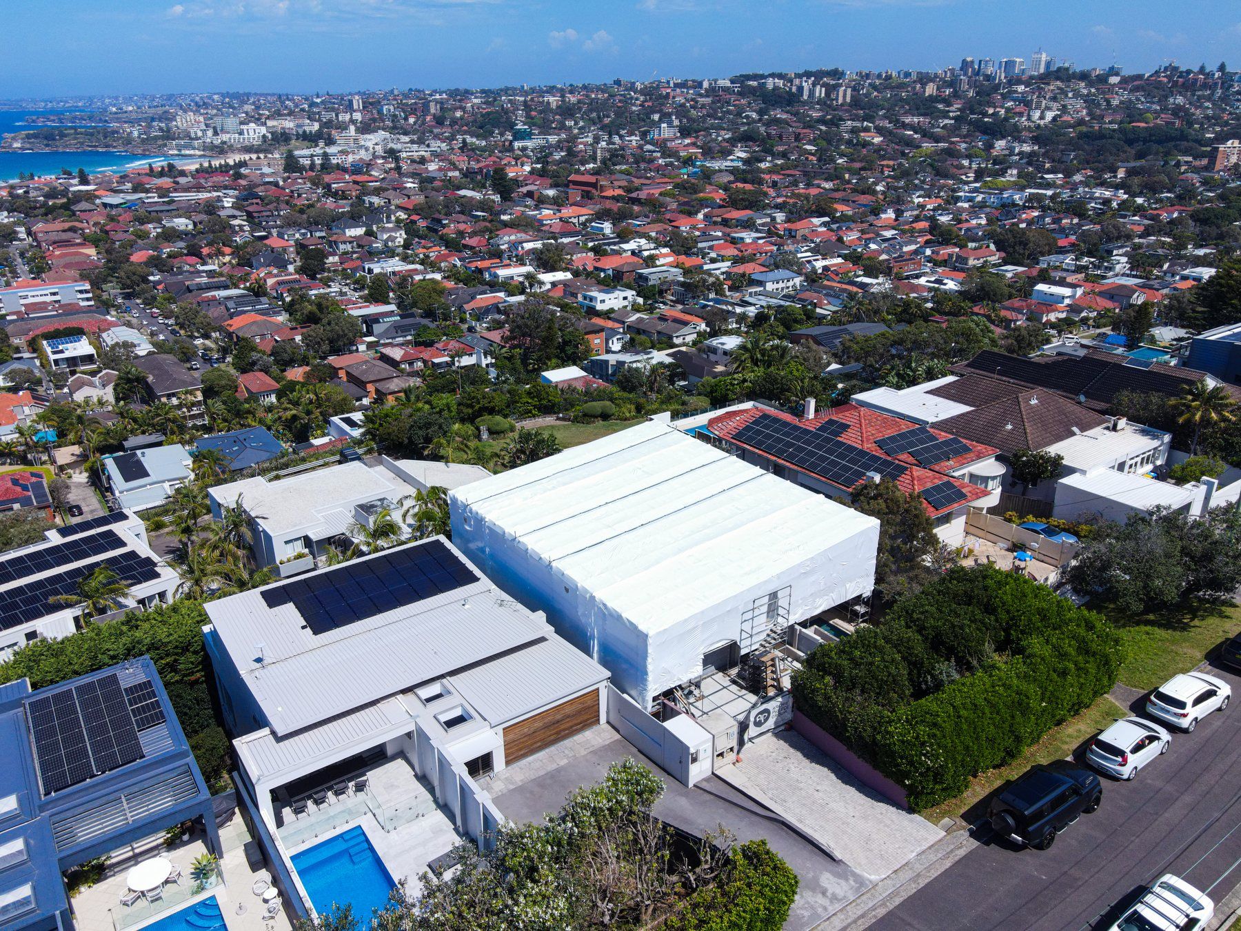 Aerial over the wrap and the neighbouring homes, the eastern suburbs stretching back to the coast