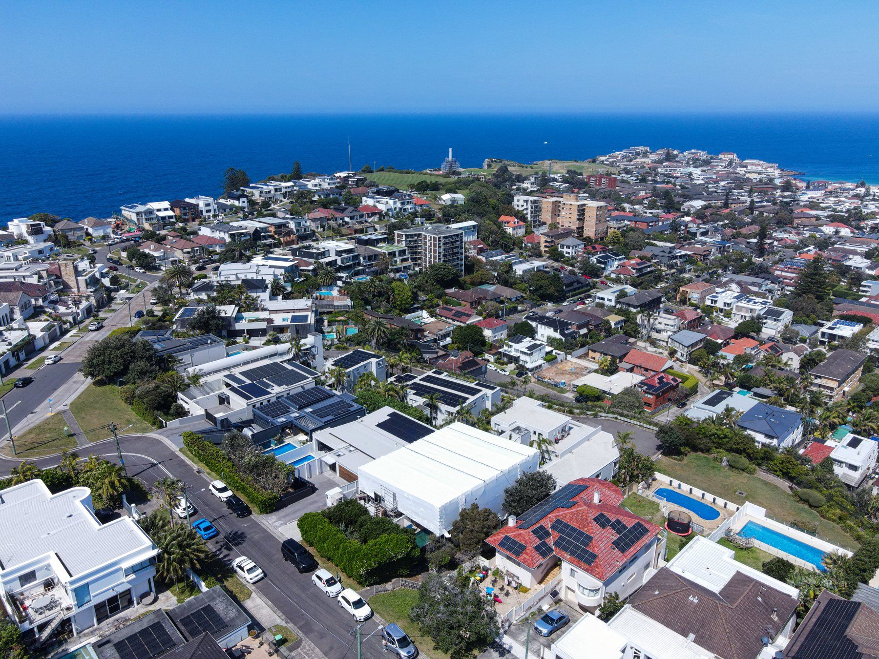 High aerial over Dover Heights to the ocean, the white wrap in the lower centre