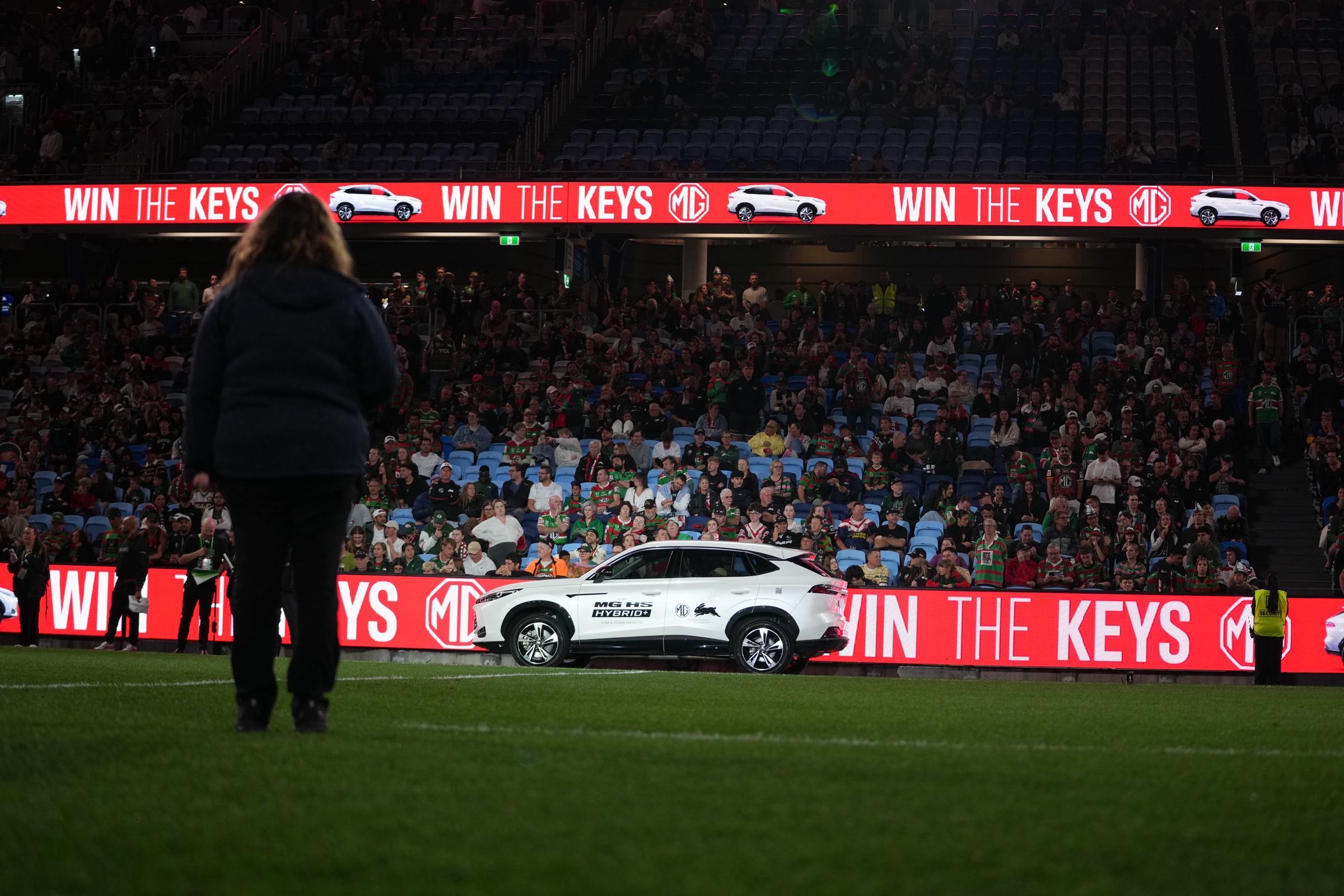 MG HS Hybrid+ on the field beside the Win the Keys LED ribbon board, Allianz Stadium