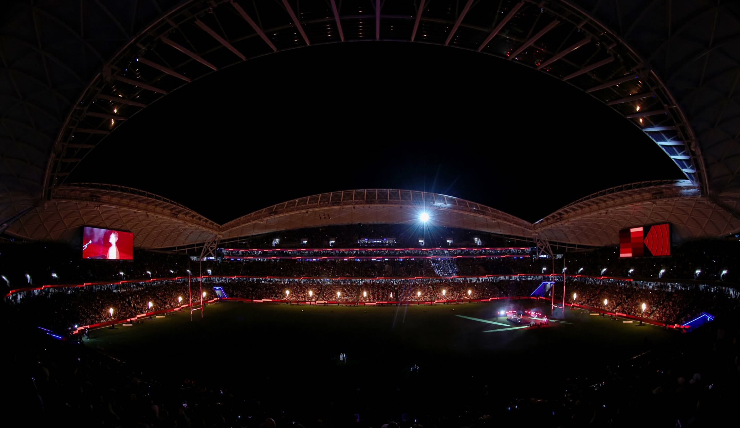 Wide night shot of Allianz Stadium during a live event, LED perimeter lit