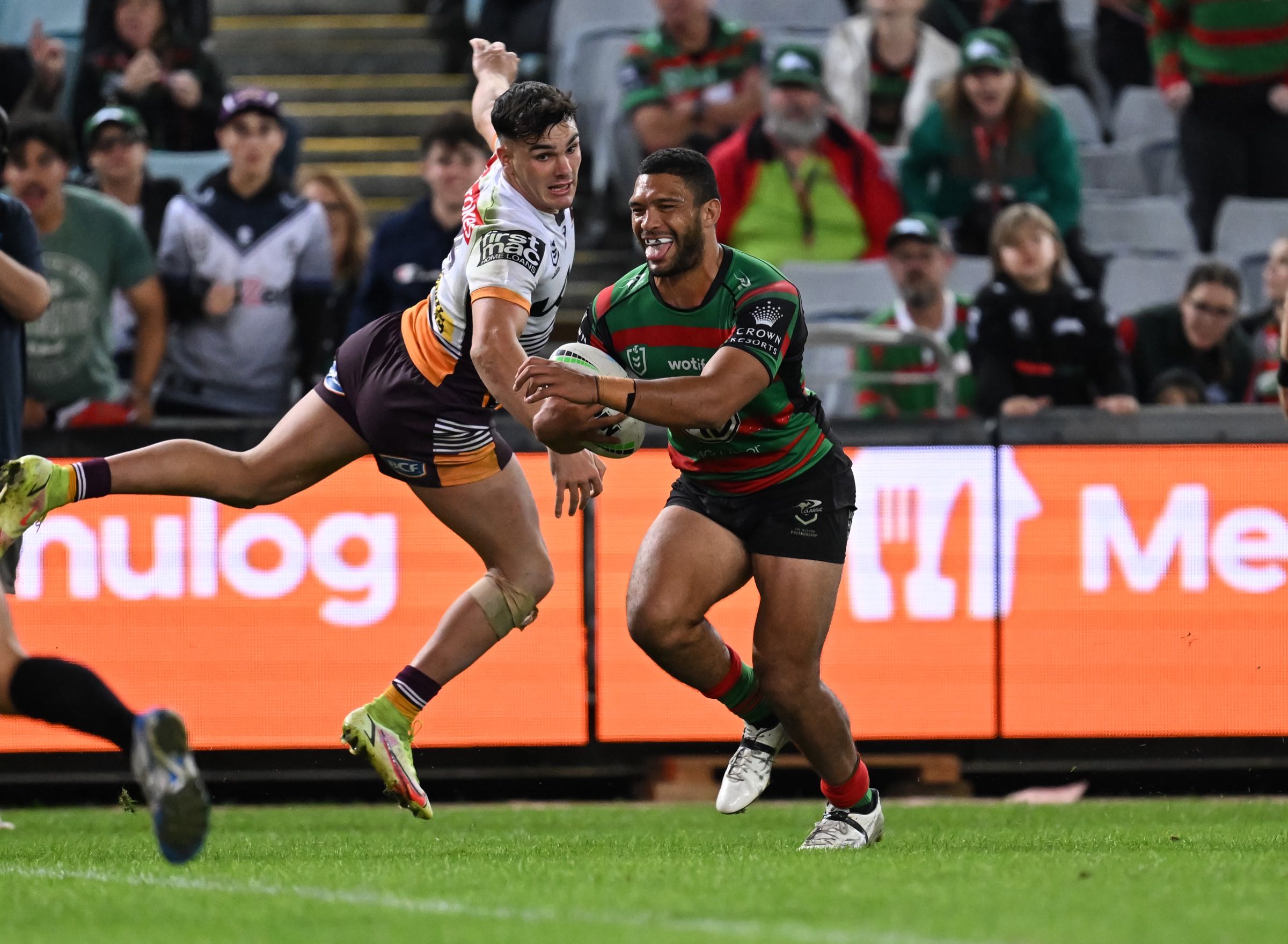 Menulog LED perimeter board partially obscured by players during live NRL play